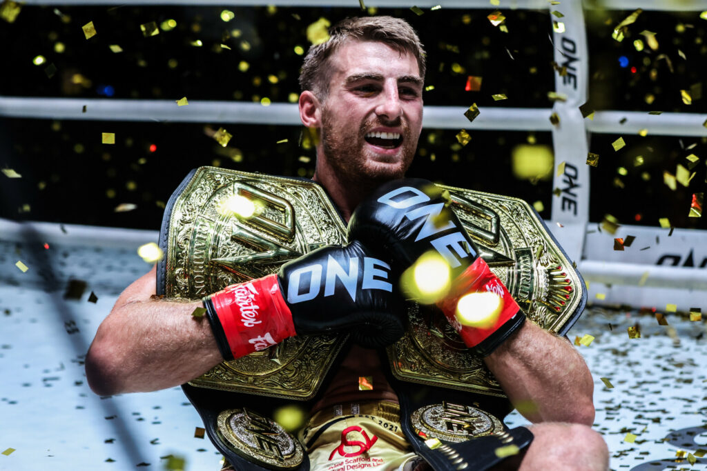 Johnathan Haggerty with 2 ONE Championship belts