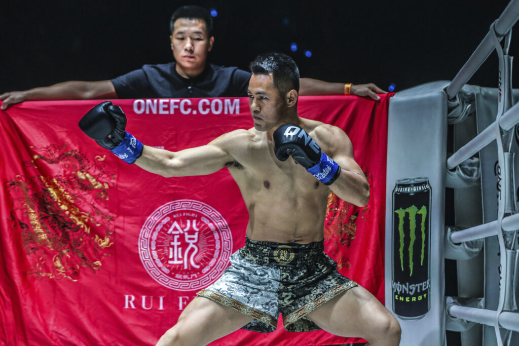 Wei Rui with a flag in the background